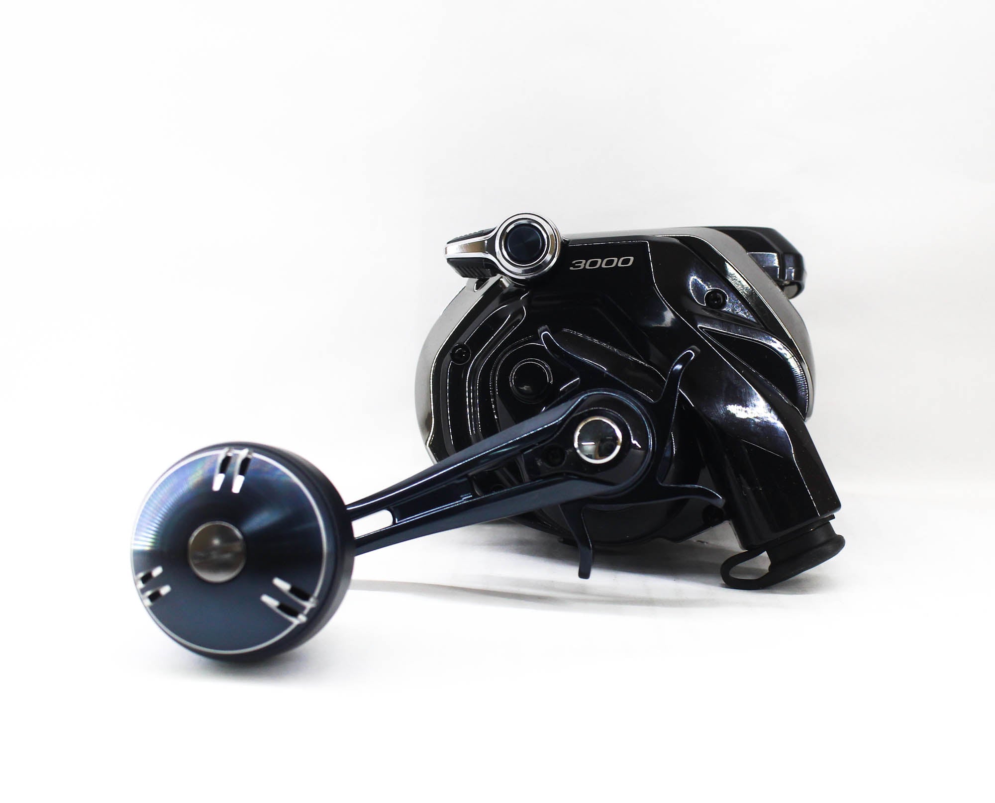Black fishing reel on a white background