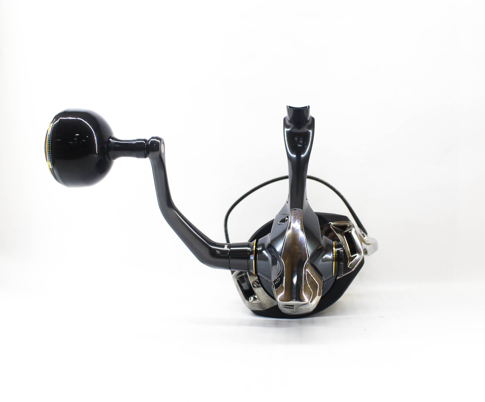 Close-up of a fishing reel on a white background